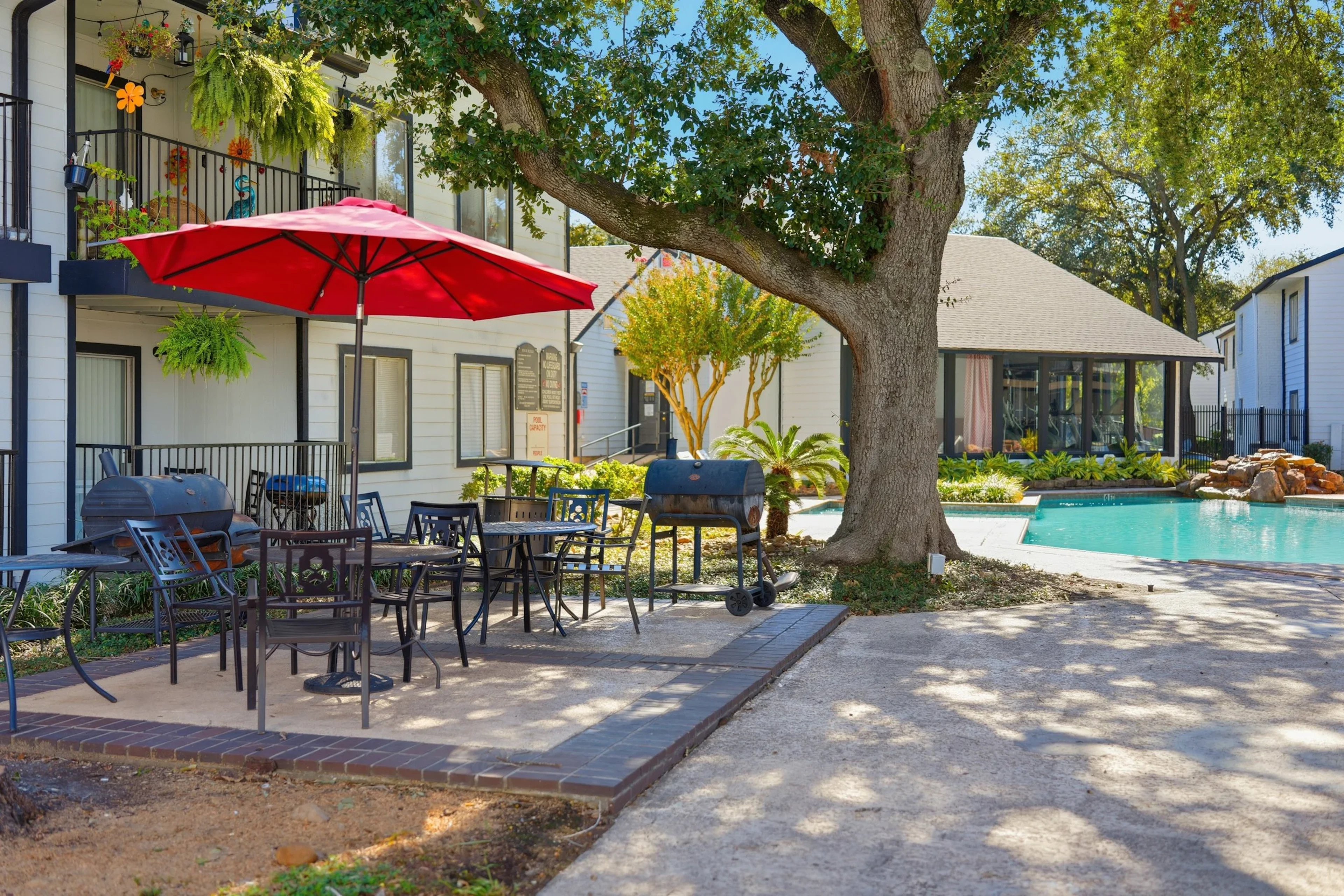 Covered patio and garden area at Woodtrail Apartment Homes.